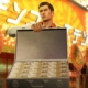 An image of Kiryu from Yakuza 0 presenting the camera a briefcase full of cash.