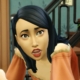 A close up of a female sim in The Sims 4 with medium-length black hair and an off-the-shoulder orange top. She