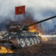 A soviet tank waving a banner against an explosion