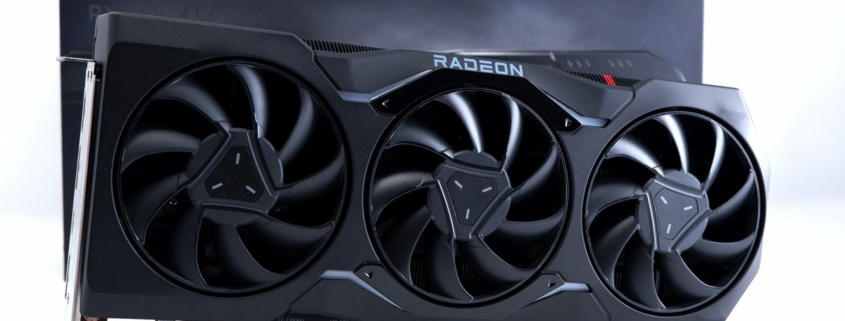 AMD Radeon RX 7900 XTX photographed with box on a white background.