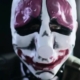 A close-up of a live-action actor wearing a Payday clown mask.