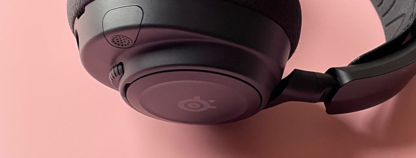 The SteelSeries Arctis Nova 7 Wireless on a pink background.