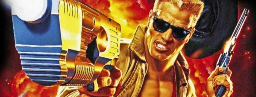 Duke Nukem with arm outstretched, pistol in hand, aiming at the screen