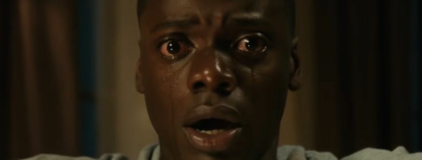 A close-up of Daniel Kaluuya shedding tears in a scene from Get Out.