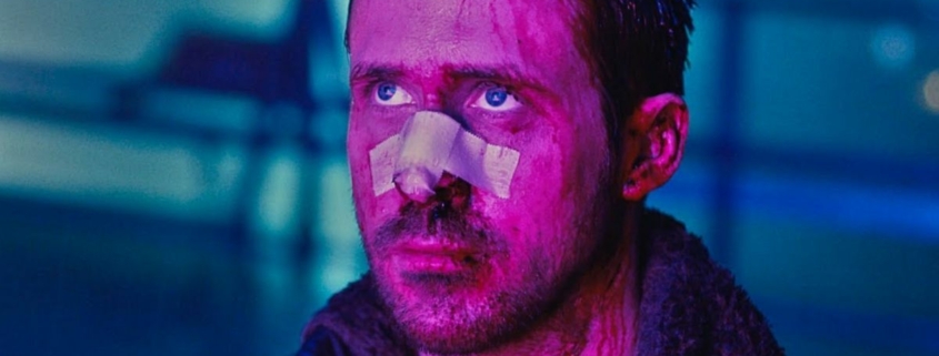 Ryan Gosling looking worse for wear looking up lit by purple light