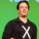 Phil Spencer giving a talk on stage, wearing a t-shirt with an