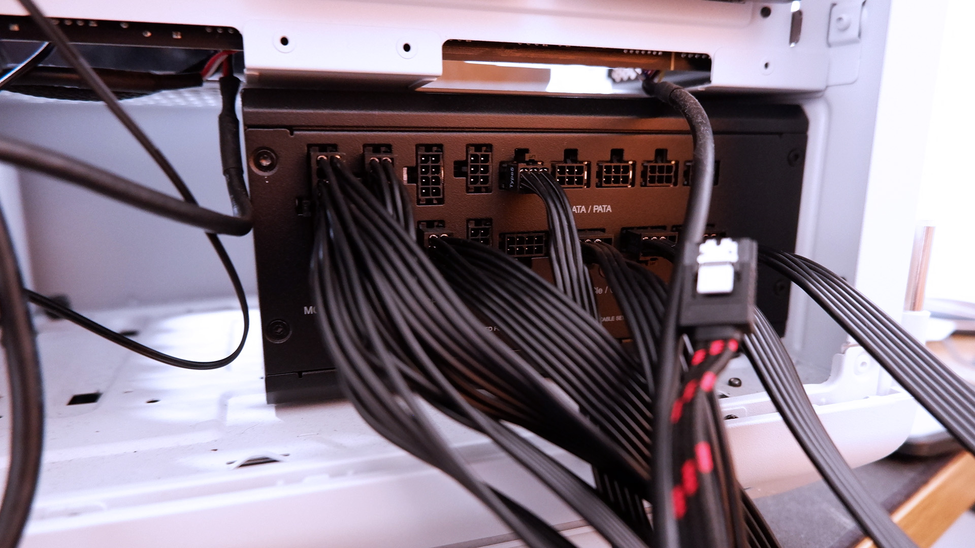 Corsair RMx SHIFT power supply being installed in a gaming PC