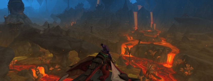 WoW 10.1 update - a shadow priest sitting on a dragonriding mount looks out over rivers of lava inside a huge cavern