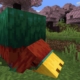 Minecraft 1.20 - a sniffer sticks its large yellow snout into the ground with cherry blossom trees in the background