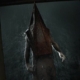 Pyramid Head stands in a doorway in Silent Hill 2.