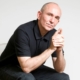 Peter Molyneux in a chair.