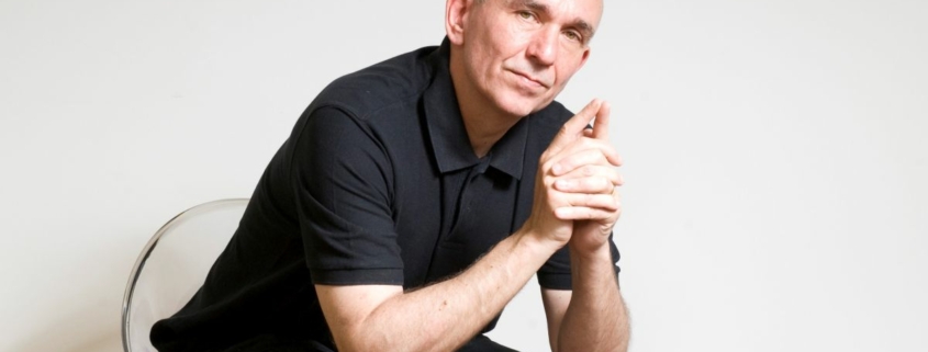 Peter Molyneux in a chair.