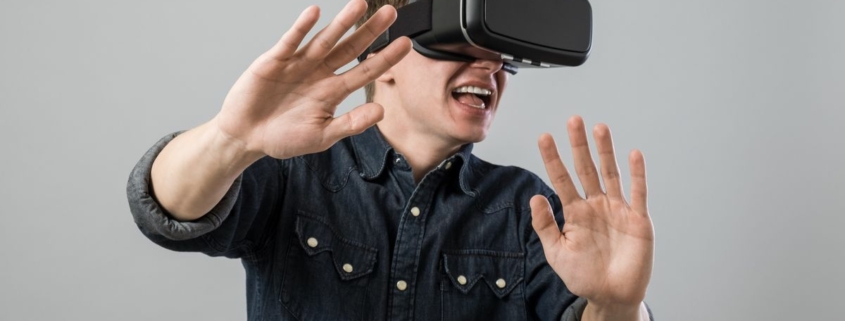 Man with hands out using a VR headset.