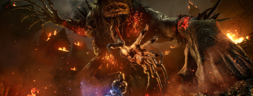 The Spurned Progeny from Lords of the Fallen looms horrifically over a player amidst burning rubble, a clawed hand tearing from its maw to snatch them up.