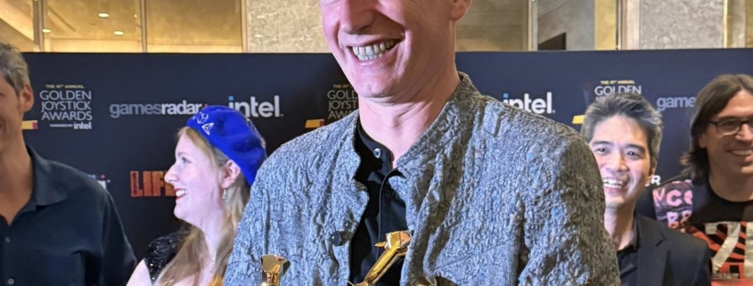 Swen Vincke with an armful of Golden Joystick Awards.