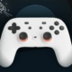 Google Stadia controller with a rocketship flying away above it