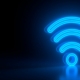 Futuristic glowing blue wi-fi symbol on black dark background with blurred reflection