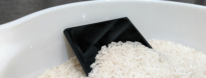 A smartphone sitting in rice