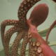 An image of a little boy riding on the tentacle of a large octopus in Chasing the Unseen.