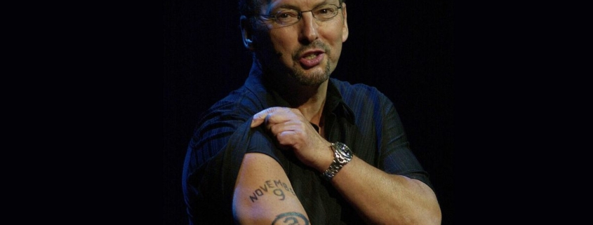 Peter Moore displaying his famous Halo 2 release date tattoo in 2004.