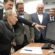 Vladimir Putin being shown something on a computer monitor