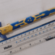 A small Master Sword replica compared against a ruler, measuring 6 inches.