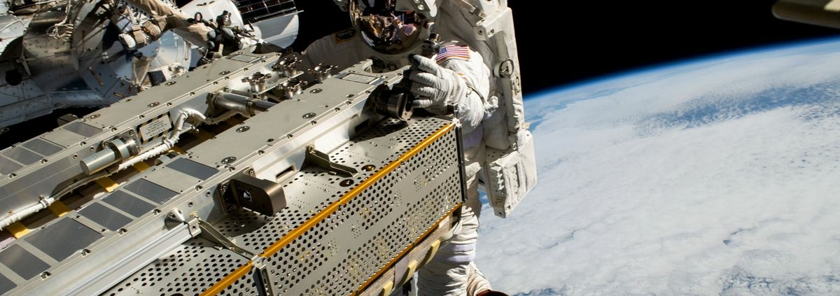 NASA astronaut and Expedition 68 Flight Engineer Woody Hoburg riding the Canadarm2 robotic arm while maneuvering a roll-out solar array toward the International Space Station’s truss structure 257 miles above the Pacific Ocean