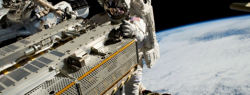 NASA astronaut and Expedition 68 Flight Engineer Woody Hoburg riding the Canadarm2 robotic arm while maneuvering a roll-out solar array toward the International Space Station’s truss structure 257 miles above the Pacific Ocean