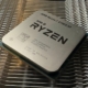 A photo of an AMD Ryzen 7 5700X3D processor resting on a metal heatsink