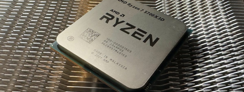 A photo of an AMD Ryzen 7 5700X3D processor resting on a metal heatsink