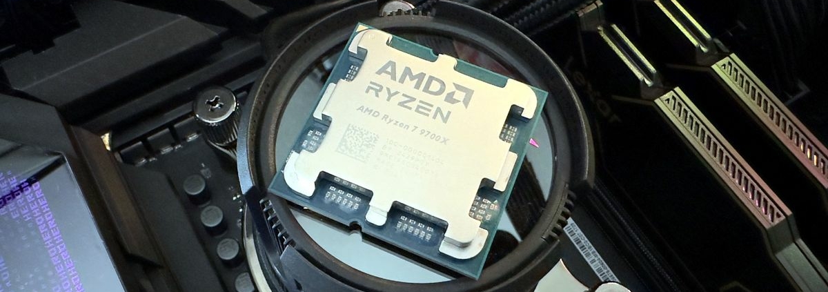 A photo of an AMD Ryzen 7 9700X processor resting on top of an Asus AIO liquid cooler