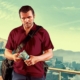 GTAV Michael holding money with Vinewood panoramic background