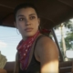 Grand Theft Auto 6 trailer still - woman in the front seat of a car, looking out the back window while holding a wad of cash