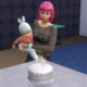 The Sims 4 - An adult Sim holds an dinfant and helps them blow out candles