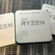 A photo of three AMD Ryzen processors resting on a metal heatsink