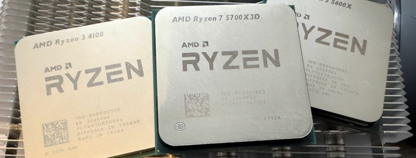 A photo of three AMD Ryzen processors resting on a metal heatsink