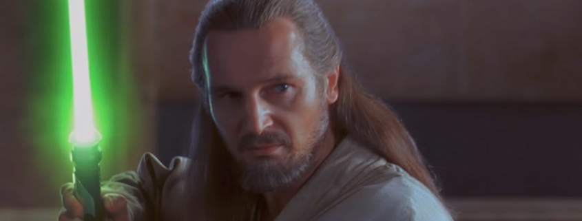 Qui Gon Jinn holding lightsaber in The Phantom Menace