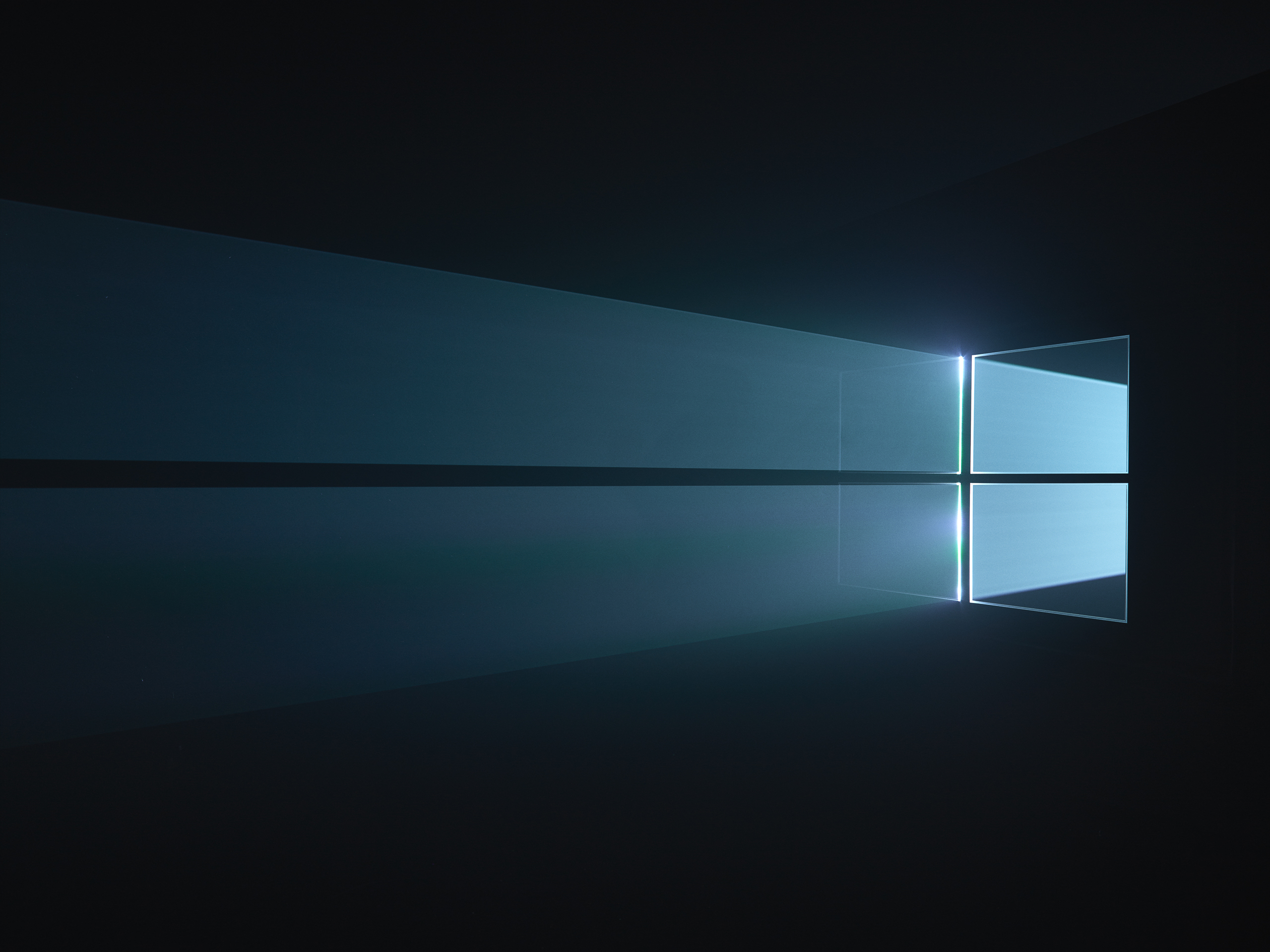 WIP versions of Windows 10 desktop background with light being filtered through a physical windows 10 logo