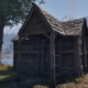 A shack next to a tree by the water