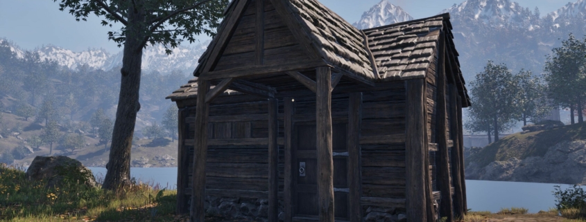 A shack next to a tree by the water