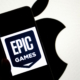 INDIA - 2024/09/14: In this photo illustration, an Epic Games logo seen displayed on a smartphone with an Apple logo in the background. The relationship between Epic Games and Apple became widely known due to a legal dispute. In 2020, Epic Games, the creator of the popular game Fortnite, challenged Apple's App Store policies by introducing a direct payment option in Fortnite, bypassing Apple's 30% commission on in-app purchases. Apple responded by removing Fortnite from the App Store, leading to a major lawsuit. Epic accused Apple of anti-competitive behavior, claiming that the company had a monopoly on app distribution and payments within its ecosystem. The case, which addressed broader issues of app store policies and digital marketplaces, attracted significant attention and sparked debate about the control tech giants have over their platforms. (Photo Illustration by Avishek Das/SOPA Images/LightRocket via Getty Images)