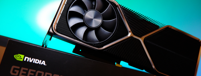 An Nvidia RTX 3080 Ti Founders Edition on top of its box on a blue background