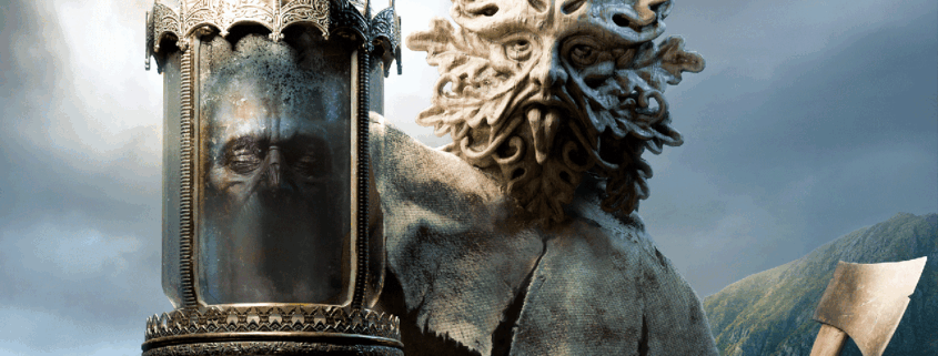 A druid wearing a demonic mask holds up a decaying head in a jar.